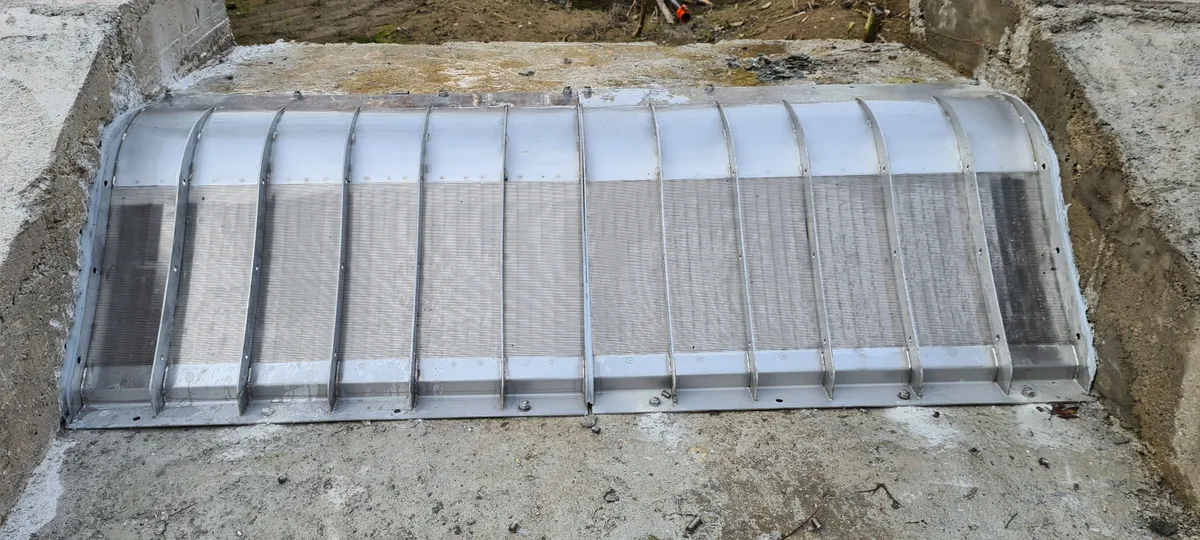 A narrow Coanda screen fitted along a concrete channel wall