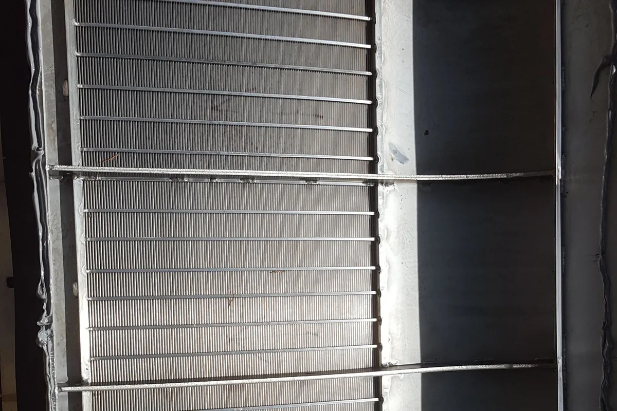 A Coanda intake screen seen from above, its wedge-wire surface and support ribs visible