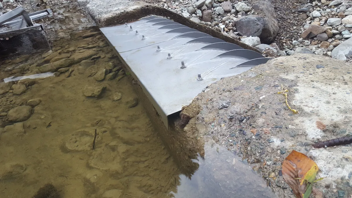 Bir taşkından sonra kısmen sedimente gömülmüş bir Coanda su alma ızgarası