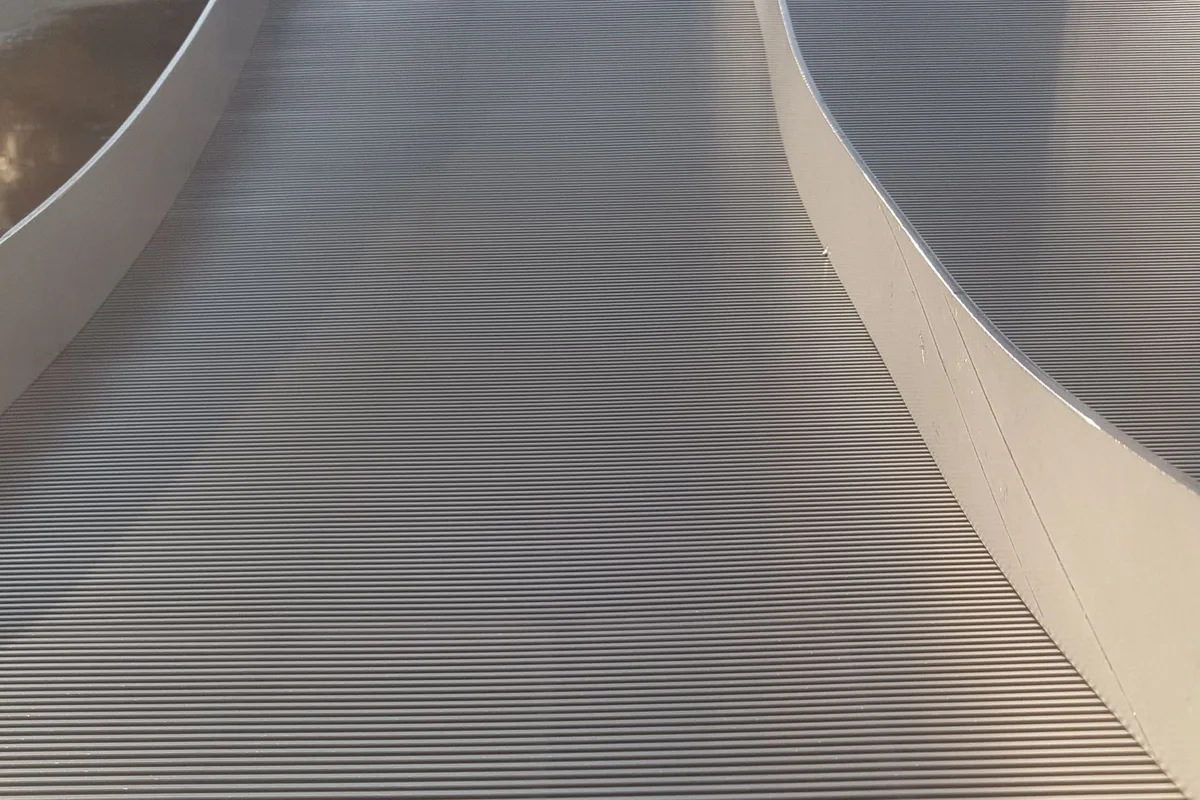 Macro view of the wedge-wire surface of a Coanda screen