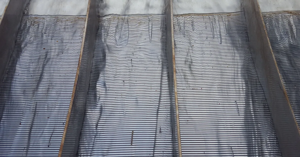 The face of an installed Coanda intake screen filling the frame, wedge-wire slots running across its full width