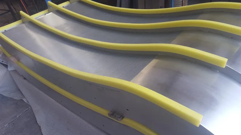 Wedge wire screen body on the factory floor with protective sleeves along the support ribs, before factory acceptance